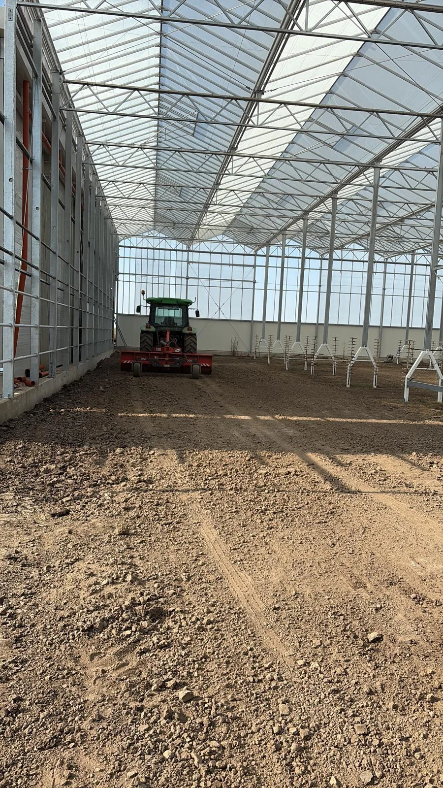 Greenhouse interior with steel structure and ground levelling works